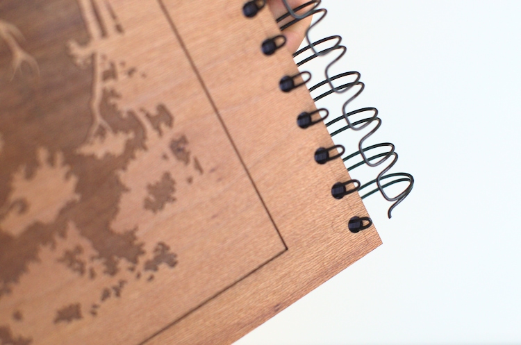 Inserting the engraved cover of the wooden notebook